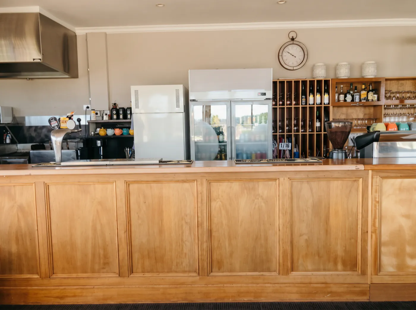 The timber bar in the Clubhouse Café, with the coffee machine, beer taps and the wine racks behind it
