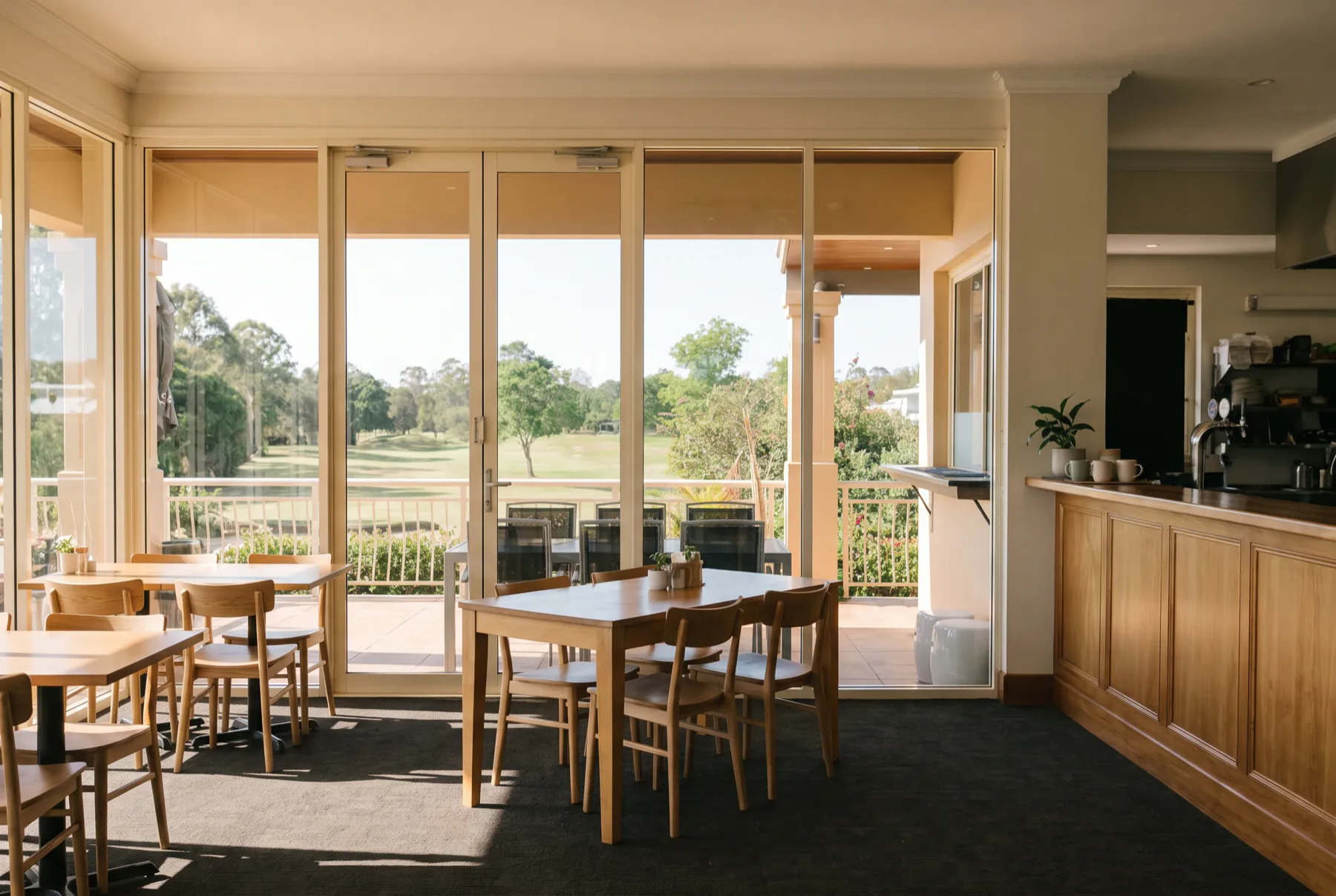 The café dining room, with glass doors opening onto the deck and the course